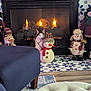 Frosty joined the competition — help win amazing prizes! cat, fireplace, snowman, decorations, penguin_plush, indoor, warm, cozy, patterned_floor, chair, plush_toys, holiday_decor, knit_hat, scarf, wood_floor, sitting, home_interior, fire, animal, feline