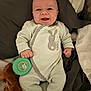 Aaron participe au concours pour gagner de l'argent avec cette photo : baby, infant, smiling, onesie, bunny, pacifier, blanket, bed, clothing, face, hands, lying_down, cute, happy, child, skin, person, indoors, comfort, soft
