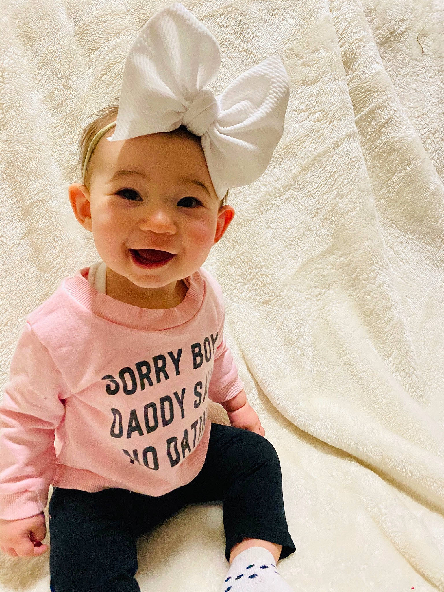 Elise is registered to the contest to win money with this photo: baby, baby_laughing, baby_toddler_clothing, child, child_model, clothing, costume_accessory, ear, fashion_accessory, hair_accessory, happy, headgear, person, pink, sleeve, smile, t_shirt, toddler, white