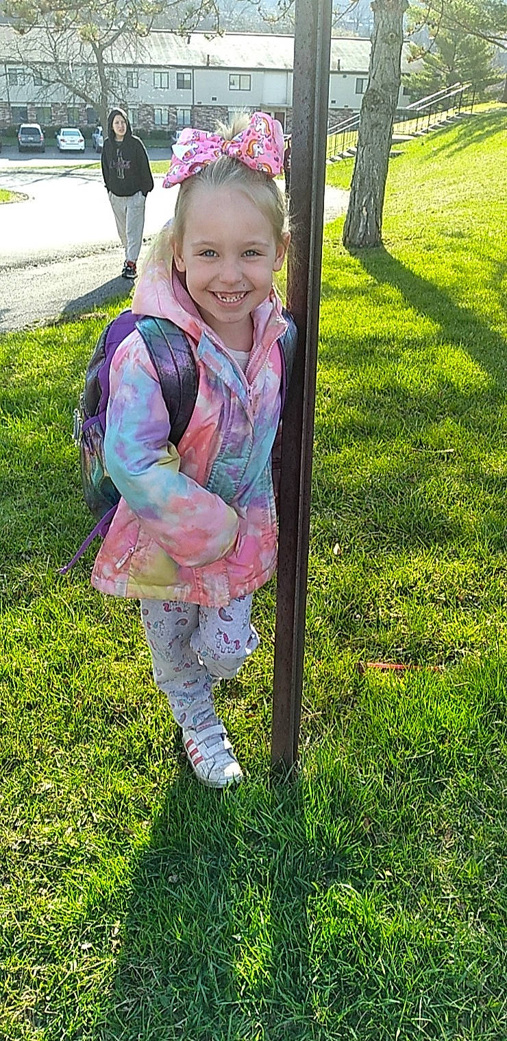 Alexis Lower is registered to the contest to win money with this photo: botany, child, facial_expression, fashion_accessory, fun, grass, grass_family, grassland, happy, joy, lawn, leisure, magenta, pattern, people_in_nature, person, pink, plant, recreation, smile