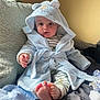Ollie is registered to the contest to win money with this photo: baby, blue_robe, bear_ears, couch, feet, infant, indoors, light, pajamas, person, plush, portrait, relaxing, sitting, soft_texture, striped_clothing, toy, warm, young_child, cozy