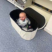 Ollie joined the competition — help win amazing prizes! baby, child, storage_basket, floor, shelf, box, indoor, smiling, clothing, footwear, toy, shopping, aisle, home_goods, container, happy, infant, store, product, retail