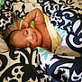 baby, sleeping, blanket, patterned_blanket, cozy, smile, child, infant, resting, cute, wrapped, soft, comfort, indoor, peaceful, portrait, human, skin, head, relaxation