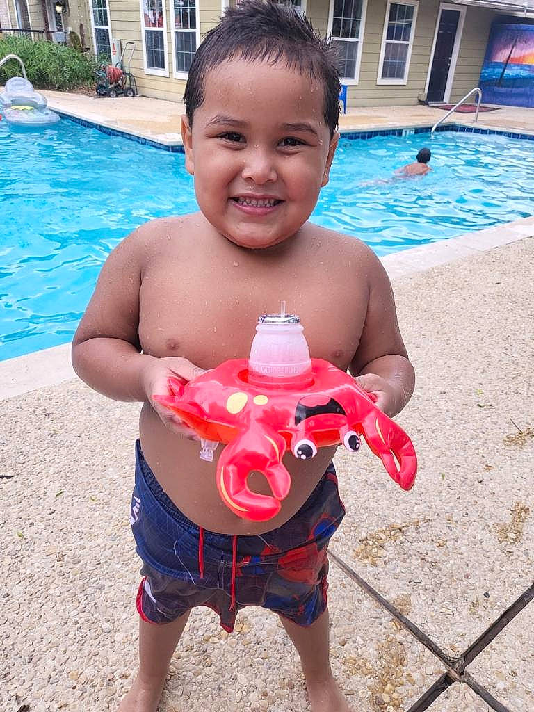 Landon is registered to the contest to win money with this photo: barechested, bathing, chest, child, fun, happy, joy, leisure, muscle, person, recreation, red, skin, smile, summer, swimming_pool, thigh, toddler, toy, trunk