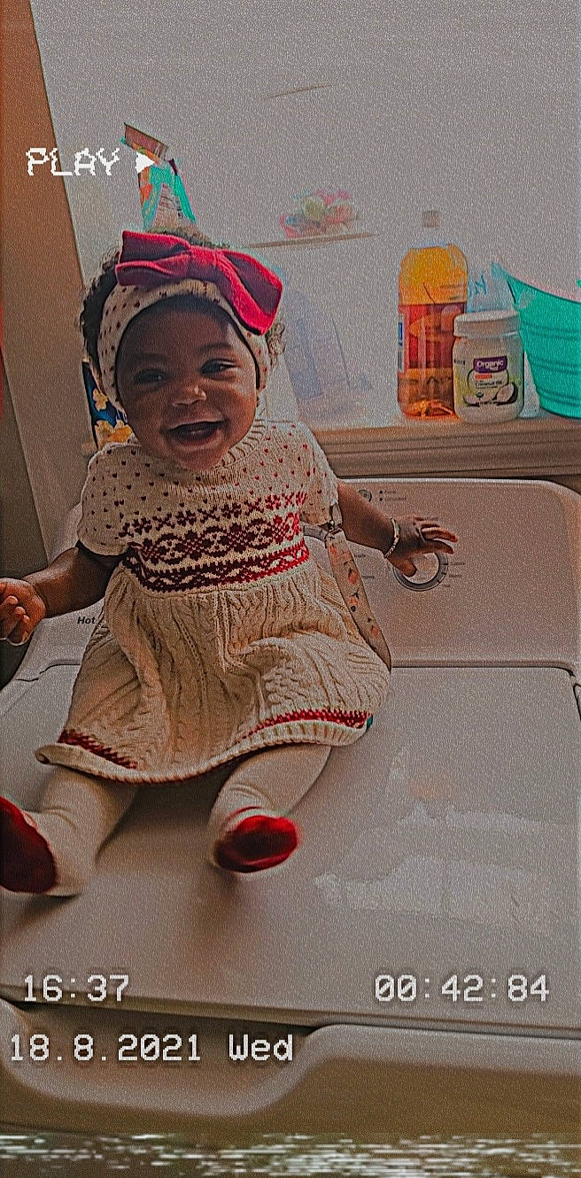 Ma'Kayla is registered to the contest to win money with this photo: baby, baby_products, baby_toddler_clothing, cap, child, fashion_accessory, flooring, font, fun, happy, hat, headgear, headwear, magenta, pattern, person, pink, product, room, smile