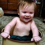 Sage joined the competition — help win amazing prizes! baby, child, pot, smiling, happy, indoor, carpet, furniture, cabinet, wood, hand, skin, hair, person, cute, playful, room, home, sitting, portrait