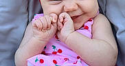 Loralie is registered to the contest to win money with this photo: baby, cherry_pattern, child, closeup, cushion, cute_expression, face, fashion, gray_background, hands, happy, infant, outdoor, pink_outfit, portrait, red_headwrap, sitting, skin, smiling, summer