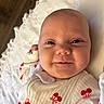 Loralie joined the competition — help win amazing prizes! baby, infant, smile, face, cute, clothing, red_cherries, blanket, soft_texture, lying_down, closeup, skin, head, eyes, mouth, cheeks, newborn, happy, indoors, portrait