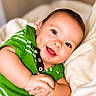 baby, infant, smile, green_shirt, blanket, happy, portrait, closeup, child, cute, face, soft, cozy, hands, young, skin, eyes, clothing, indoors, person