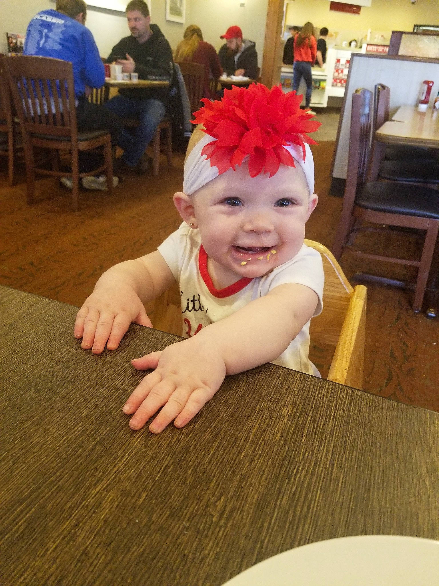 Oaklynn is registered to the contest to win money with this photo: baby, child, face, floor, flooring, fun, hair_accessory, head, headband, headgear, joy, person, smile, toddler, wood