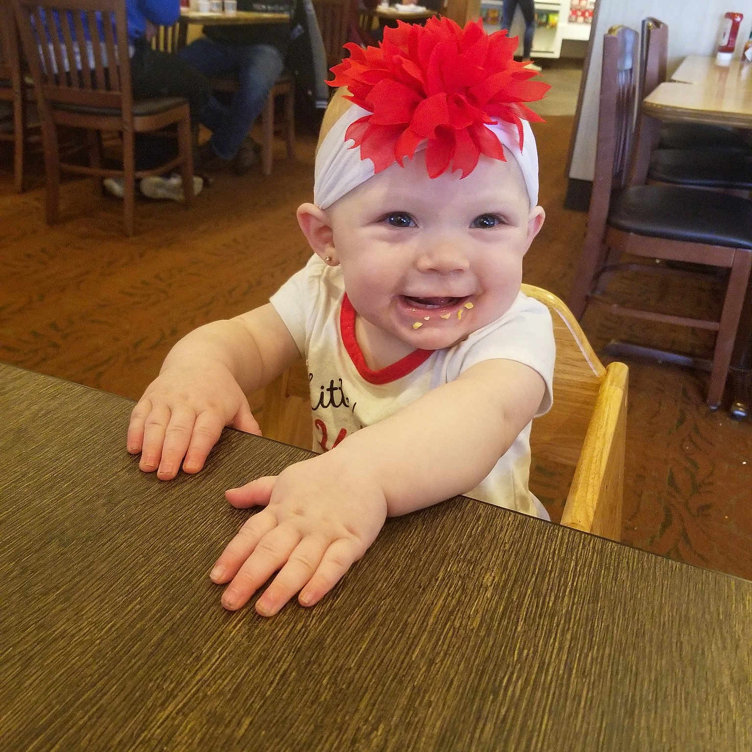 Oaklynn is registered to the contest to win money with this photo: baby, child, face, floor, flooring, fun, hair_accessory, head, headband, headgear, joy, person, smile, toddler, wood