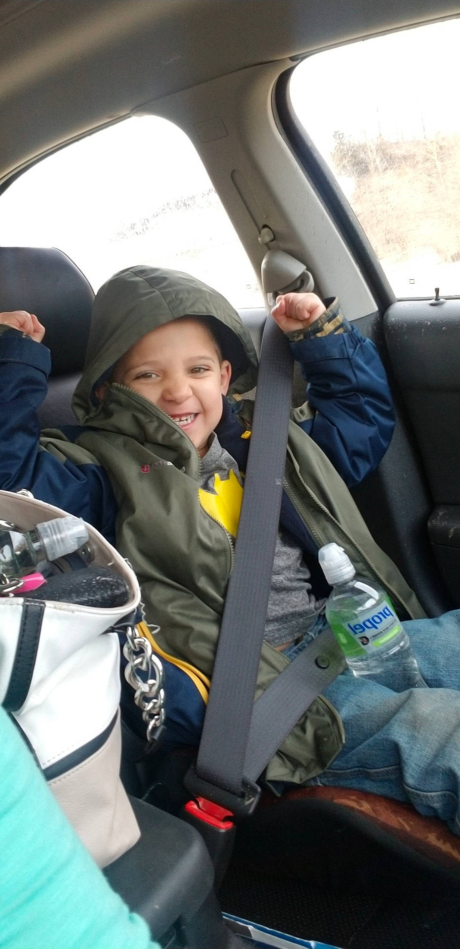 Kegan is registered to the contest to win money with this photo: car_seat, joy, person, seat_belt, vehicle