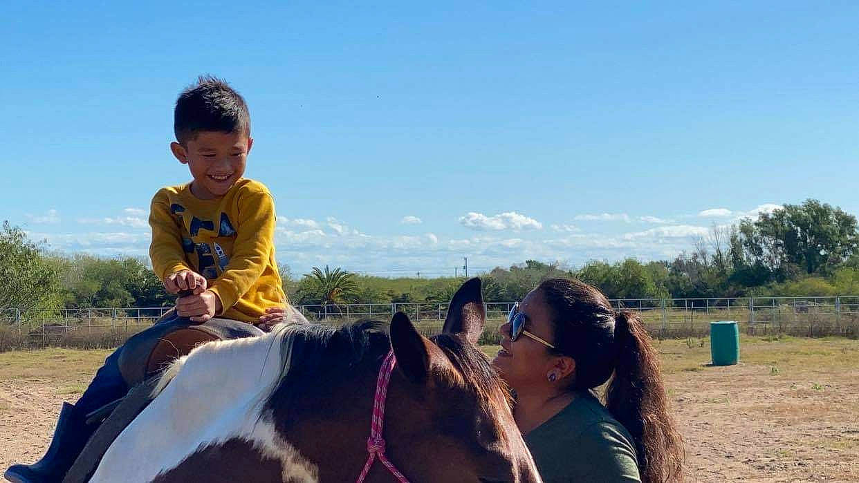 Gregson is registered to the contest to win money with this photo: animal_sports, equestrianism, equitation, farm, horse, horse_supplies, horse_tack, human, joy, livestock, mammal, mane, mare, person, prairie, ranch, rein, rural_area, saddle, toddler