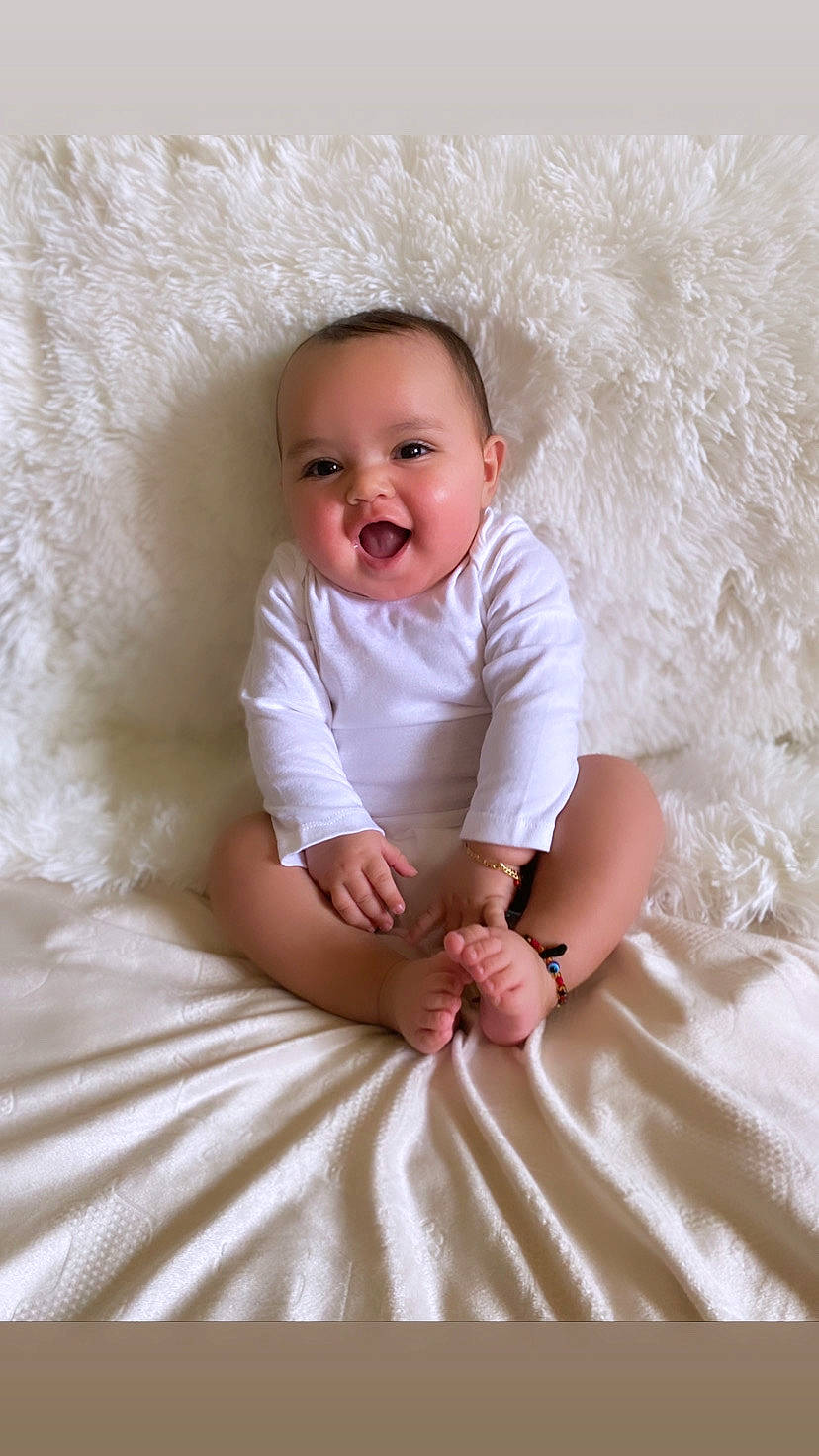 Lunarae is registered to the contest to win money with this photo: baby, baby_toddler_clothing, cheek, child, comfort, dress, eye, facial_expression, flash_photography, happy, linens, mammal, peach, person, pink, skin, sleeve, smile, t_shirt, textile