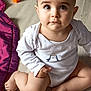 baby, child, infant, onesie, floor, wooden_floor, blanket, toy_block, penguin_print, cute, sitting, chubby_legs, curious_eyes, indoors, soft_lighting, portrait, person, skin, clothing, flooring