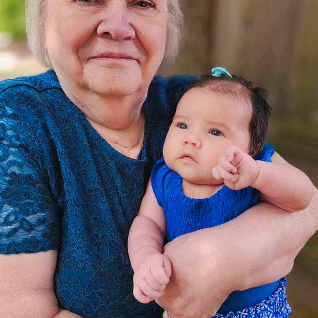 Raziah Morgan is registered to the contest to win money with this photo: affection, baby, blue_clothing, casual_wear, closeup, elderly_woman, face, family, head, holding, human, love, nature, outdoor, person, portrait, skin, smile, tenderness, tree