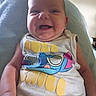 Wyllo is registered to the contest to win money with this photo: arm, baby, blanket, cartoon, casual, child, clothing, colorful, cute, face, happy, head, indoors, infant, person, portrait, sitting, skin, smiling, tshirt