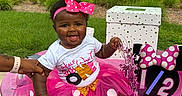 Amoni is registered to the contest to win money with this photo: baby, child, tutu, pink, bow, smile, happy, celebration, party, outdoor, grass, decoration, table, minnie_mouse, half_birthday, person, cute, toddler, headband, festive