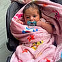 baby, blanket, car_seat, pacifier, infant, pink, star_pattern, wrapped, cute, indoor, child, face, small_hands, cozy, portrait, newborn, soft, comfort, looking, resting
