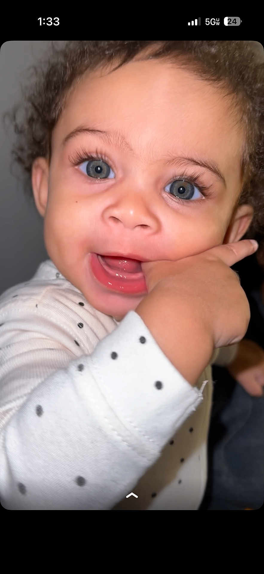 Zanova joined the competition — help win amazing prizes! baby, child, face, hand, blue_eyes, curly_hair, white_clothing, polka_dots, cute, close_up, expression, portrait, infant, playful, chewing, skin, person, young_child, indoors, smiling