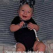 Oaklynn is registered to the contest to win money with this photo: accessories, baby, barefoot, bodypart, clothing, couch, cushion, dress, face, furniture, happy, head, homedecor, jewelry, necklace, newborn, person, photography, portrait, sitting