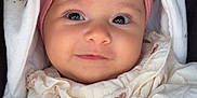 Liana participe au concours pour gagner de l'argent avec cette photo : baby, infant, face, headband, flower, smile, hand, blanket, clothing, cute, portrait, closeup, child, warm, soft, cozy, newborn, adorable, expression, wrapped
