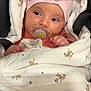 baby, infant, pacifier, blanket, pink_hat, bow, bunny_pattern, soft_fabric, wrapped, cute, child, newborn, face, expression, cozy, warm, indoors, portrait, hand, sleepy