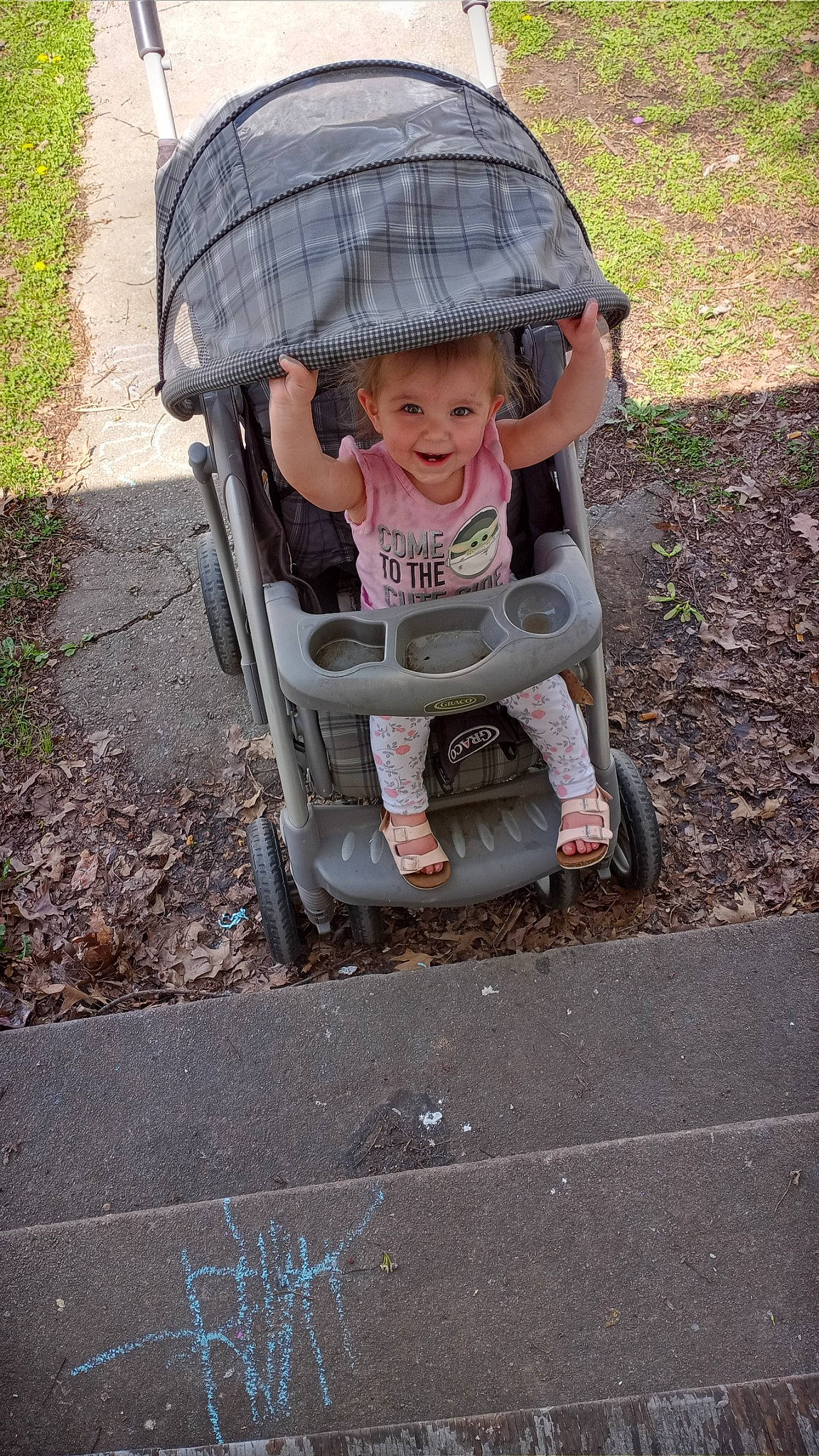Lylah is registered to the contest to win money with this photo: auto_part, baby, baby_carriage, baby_products, baby_safety, baby_toddler_clothing, child, comfort, face, fun, grass, hat, headwear, joy, person, plant, product, road_surface, sitting, smile