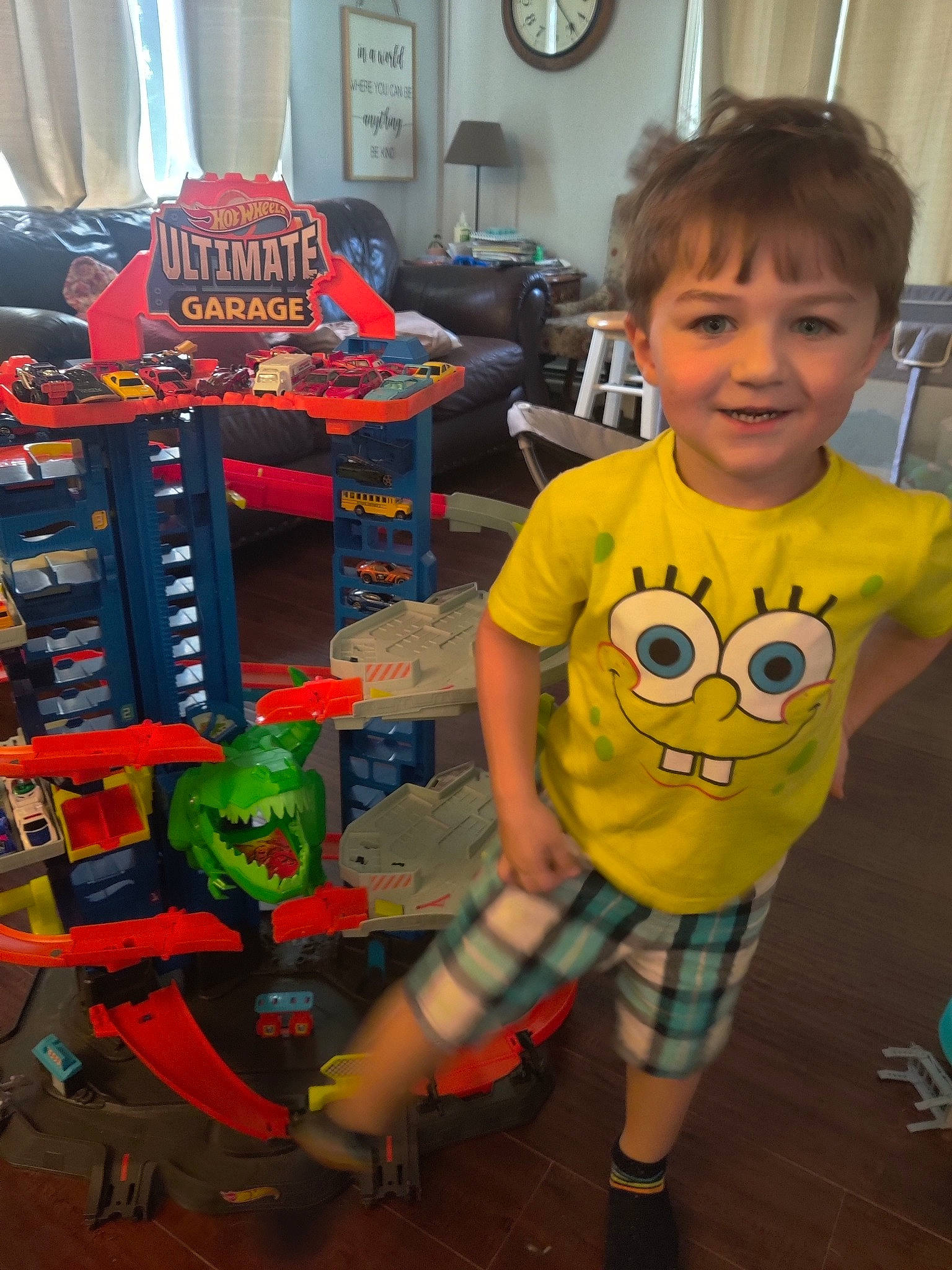 Lukas is registered to the contest to win money with this photo: baby_toddler_clothing, chair, child, clock, engineering, flooring, fun, happy, joy, machine, pattern, person, play, room, shelf, shorts, sleeve, smile, standing, t_shirt
