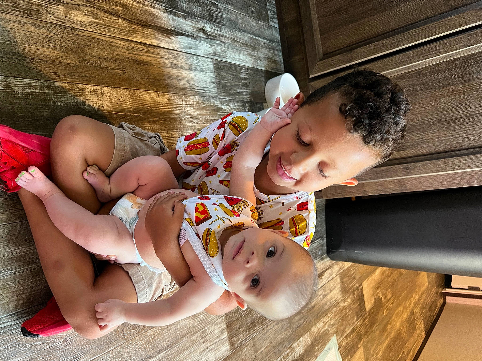Kalani Jade is registered to the contest to win money with this photo: abdomen, baby, baby_toddler_clothing, barefoot, child, comfort, eye, facial_expression, flooring, foot, fun, happy, human_leg, mammal, person, sitting, skin, smile, thigh, toddler