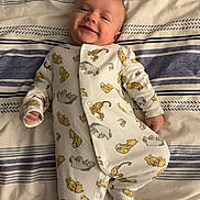 Oscar joined the competition — help win amazing prizes! baby, infant, smile, onesie, winnie_the_pooh, bed, blanket, striped, sleepwear, child, cute, comfort, lying_down, happy, portrait, young_child, indoors, soft_lighting, fabric, cozy