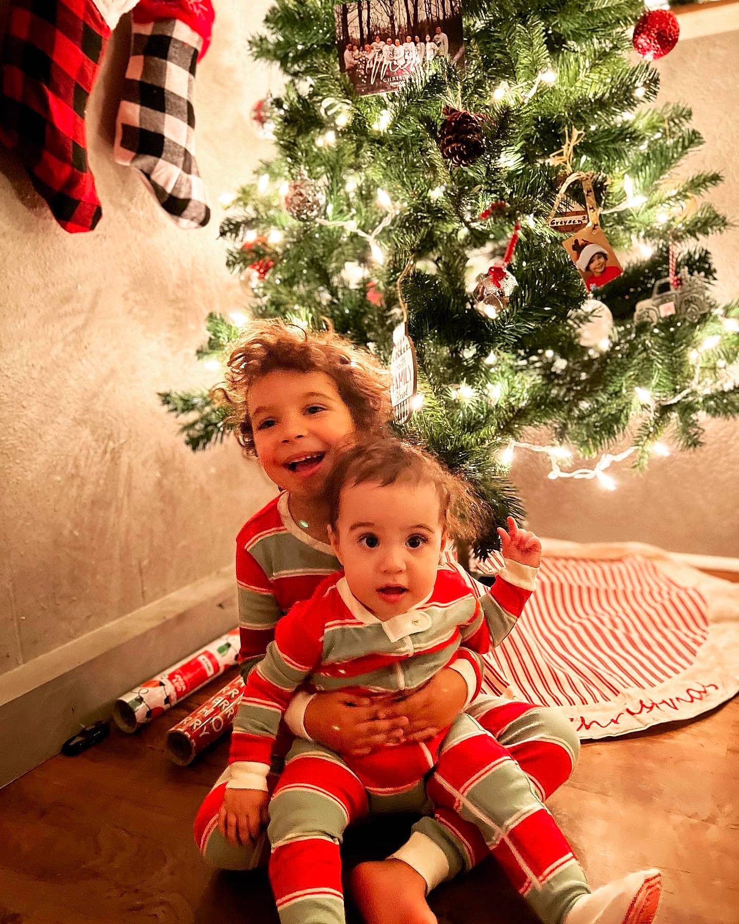 Greysen joined the competition — help win amazing prizes! christmas_decoration, christmas_ornament, christmas_tree, facial_expression, fun, happy, head, holiday_ornament, joy, lap, organ, ornament, person, photograph, plant, red, shoe, smile, standing, surprise