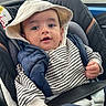 baby, child, car_seat, hat, striped_clothing, navy_vest, seatbelt, car_interior, window, rain, face, hand, clothing, portrait, infant, cute, expression, sitting, young_child, casual