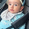 baby, child, car_seat, blue_cap, bib, straps, sitting, curious, wide_eyes, clothing, seatbelt, indoor, person, infant, portrait, casual, cute, young, headwear, seat