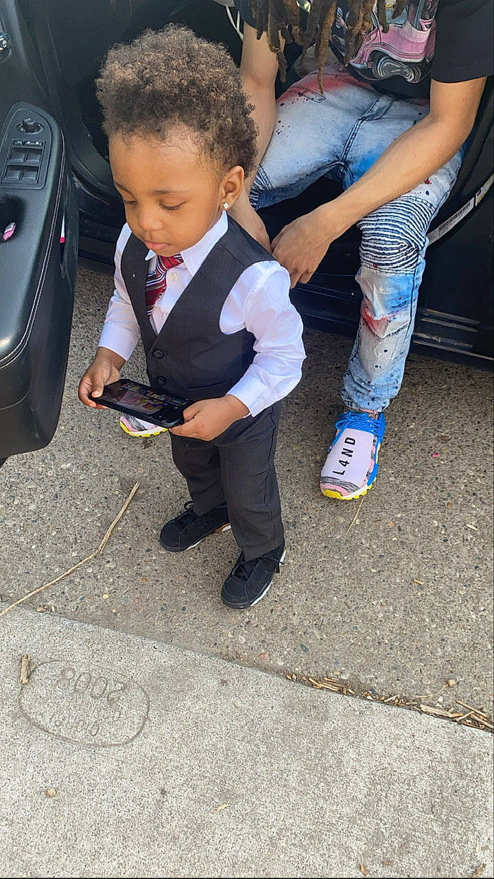 Kennan is registered to the contest to win money with this photo: asphalt, audio_equipment, chair, child, denim, electric_blue, event, formal_wear, fun, gadget, gesture, human_leg, leg, people, person, road_surface, shoe, sneakers, street_fashion, thigh