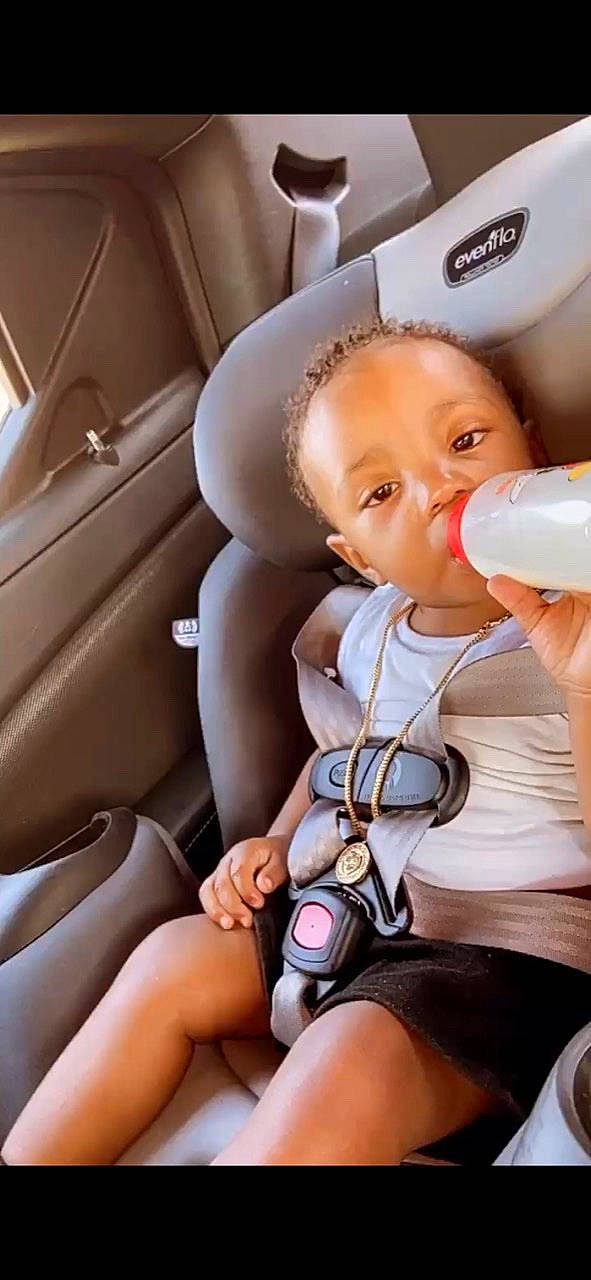 Kennan is registered to the contest to win money with this photo: automotive_design, baby, baby_bottle, car_seat, car_seat_cover, child, comfort, finger, hand, head, head_restraint, nail, person, plastic_bottle, seat_belt, skin, steering_wheel, thigh, thumb, toddler