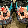 Emily And Allison is registered to the contest to win money with this photo: babies, infants, sleeping, car_seats, bows, matching, siblings, twins, indoors, transportation, safety_harness, seated, pink_clothing, blankets, baby_bottles, carriers, portrait, faces, nursery, photography