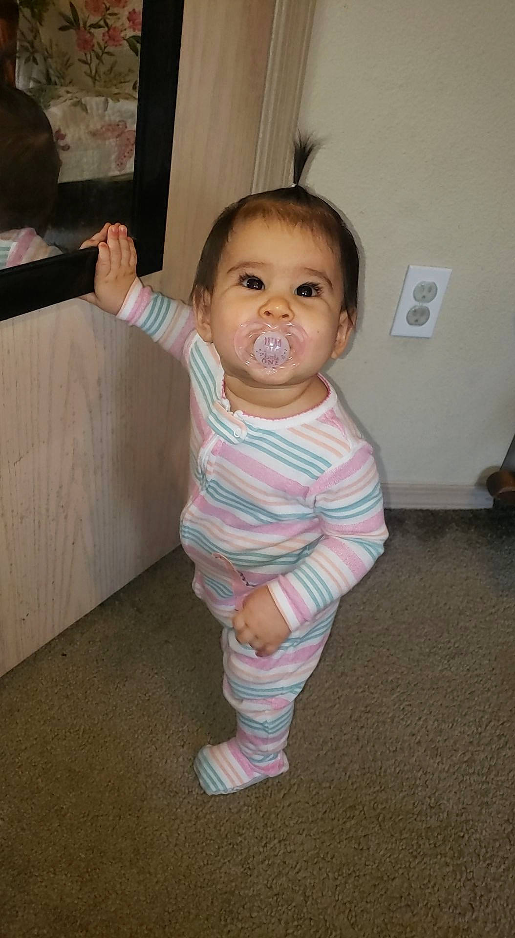 Lola joined the competition — help win amazing prizes! baby, baby_toddler_clothing, cheek, child, face, floor, flooring, fun, gesture, hardwood, human_body, iris, nose, pattern, person, sitting, sleeve, sock, thumb, toddler