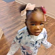 Nah'Jayla Green is registered to the contest to win money with this photo: child, toddler, girl, portrait, face, smiling, standing, indoors, home, wooden_floor, bows, hair_accessories, pink_shoes, patterned_clothing, dress, long_sleeves, fashion, motion_blur, hallway, floor