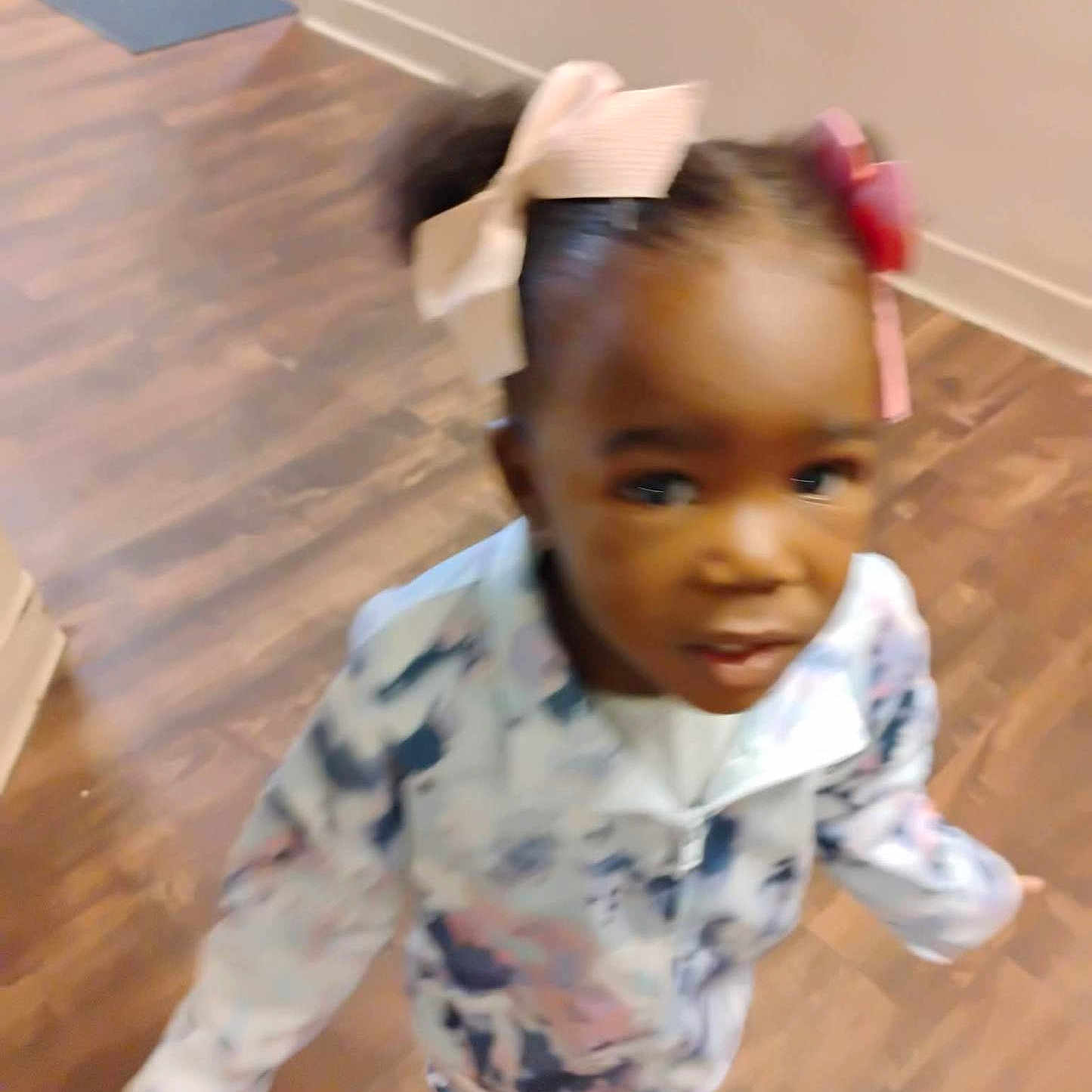 Nah'Jayla Green is registered to the contest to win money with this photo: child, toddler, girl, portrait, face, smiling, standing, indoors, home, wooden_floor, bows, hair_accessories, pink_shoes, patterned_clothing, dress, long_sleeves, fashion, motion_blur, hallway, floor