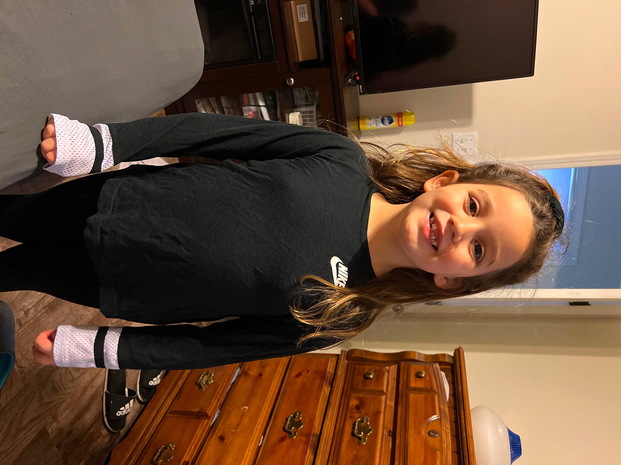 Mckenzie is registered to the contest to win money with this photo: comfort, display_device, elbow, flooring, fun, hardwood, home_appliance, human_leg, joint, joy, knee, led_backlit_lcd_display, person, room, smile, sportswear, television, television_set, thigh, varnish