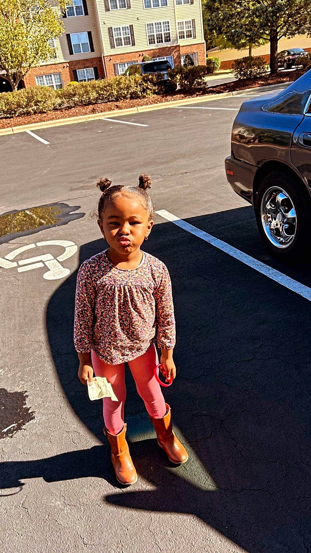 Harmonii is registered to the contest to win money with this photo: car, child, city, clothing, face, female, footwear, girl, head, machine, pedestrian, person, shoe, sitting, sleeve, standing, transportation, urban, vehicle, wheel