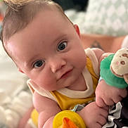 Osiris joined the competition — help win amazing prizes! baby, infant, face, eyes, hair, toy, plush_toy, hand, skin, clothing, yellow, cute, child, portrait, indoors, soft_focus, smile, person, holding, cozy