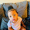 Faith joined the competition — help win amazing prizes! toddler, child, baby, couch, pillow, blanket, striped_shirt, curly_hair, indoors, seated, plaid, expression, cute, person, portrait, looking_up, skin, face, clothing, home