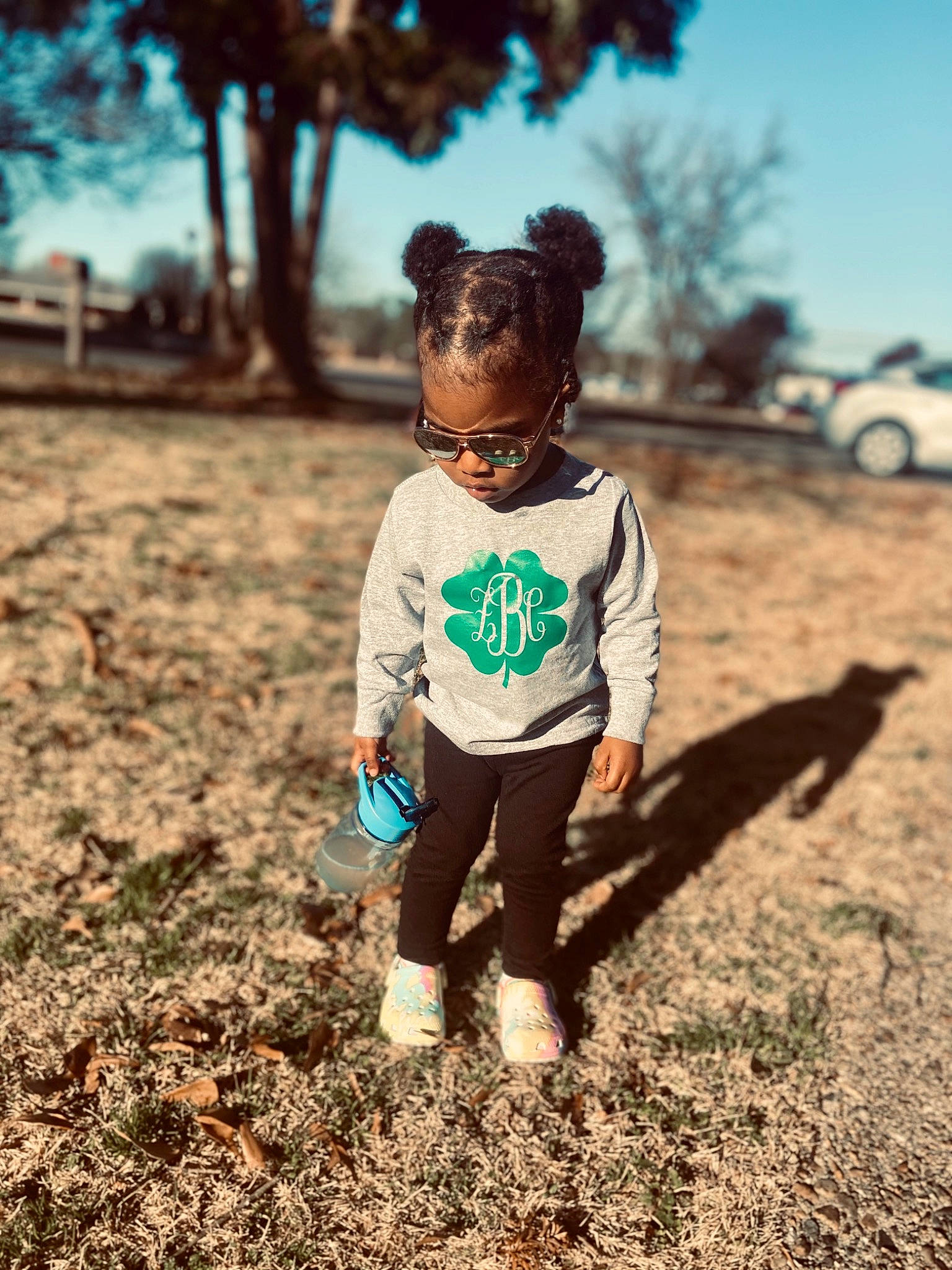 Zariya is registered to the contest to win money with this photo: denim, eyewear, fawn, fun, grass, happy, landscape, leaf, nature, people_in_nature, person, sand, sky, sleeve, standing, summer, sunlight, t_shirt, tints_and_shades, toddler