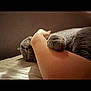 Jasper is registered to the contest to win money with this photo: cat, gray_cat, pet, animal, paw, arm, human, bed, indoor, cozy, relaxed, soft_light, fur, clutching, resting, cute, companion, domestic, comfort, intimate