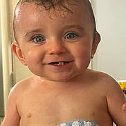 Thomas joined the competition — help win amazing prizes! baby, child, smiling, wet_hair, towel, blue, striped, teeth, face, portrait, cute, happy, indoor, skin, head, eyes, mouth, person, infant, expression