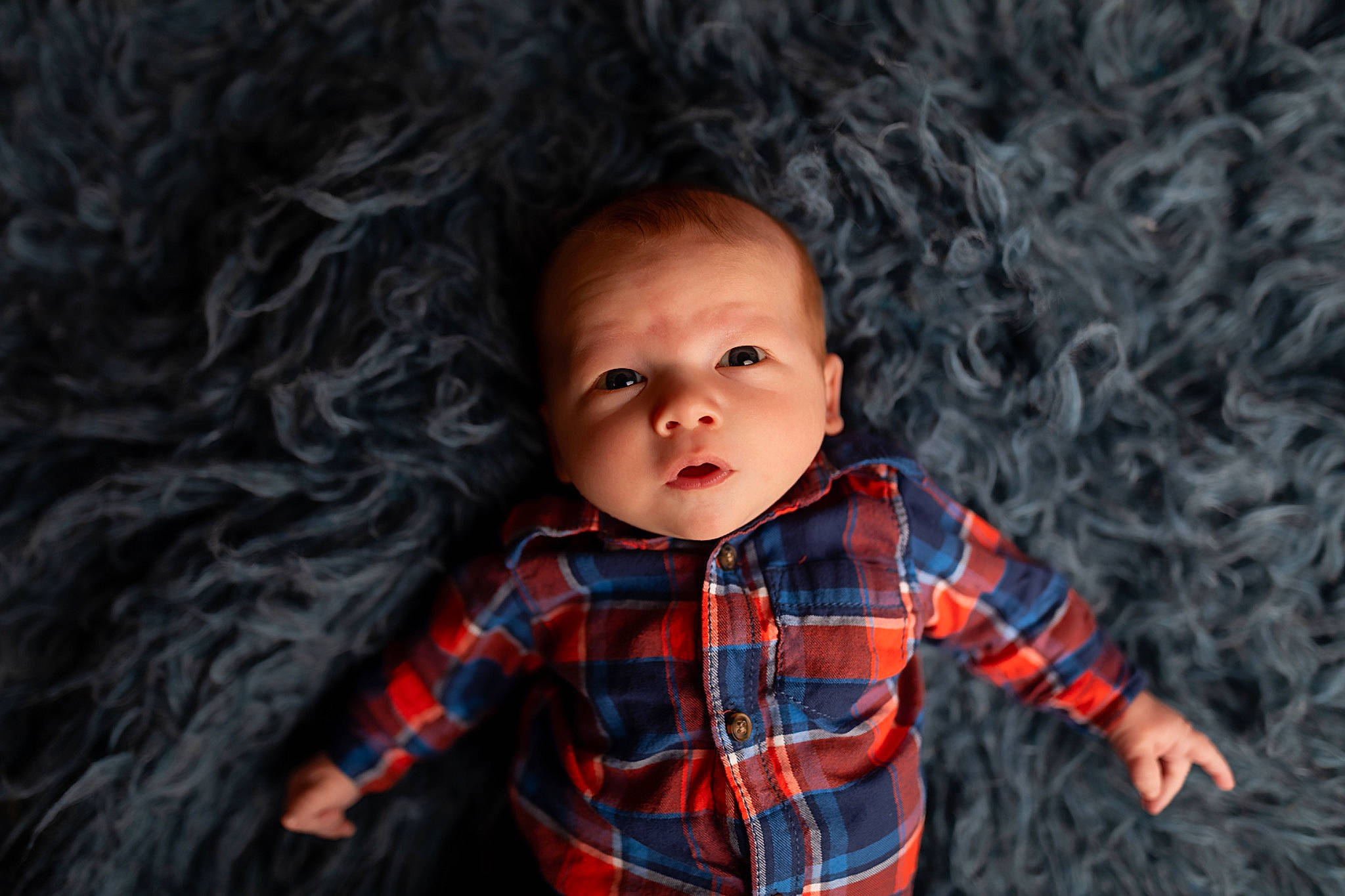 Carson is registered to the contest to win money with this photo: baby, cheek, child, design, eye, face, head, lip, nose, pattern, person, photography, plaid, portrait, portrait_photography, skin, smile, tartan, textile, toddler