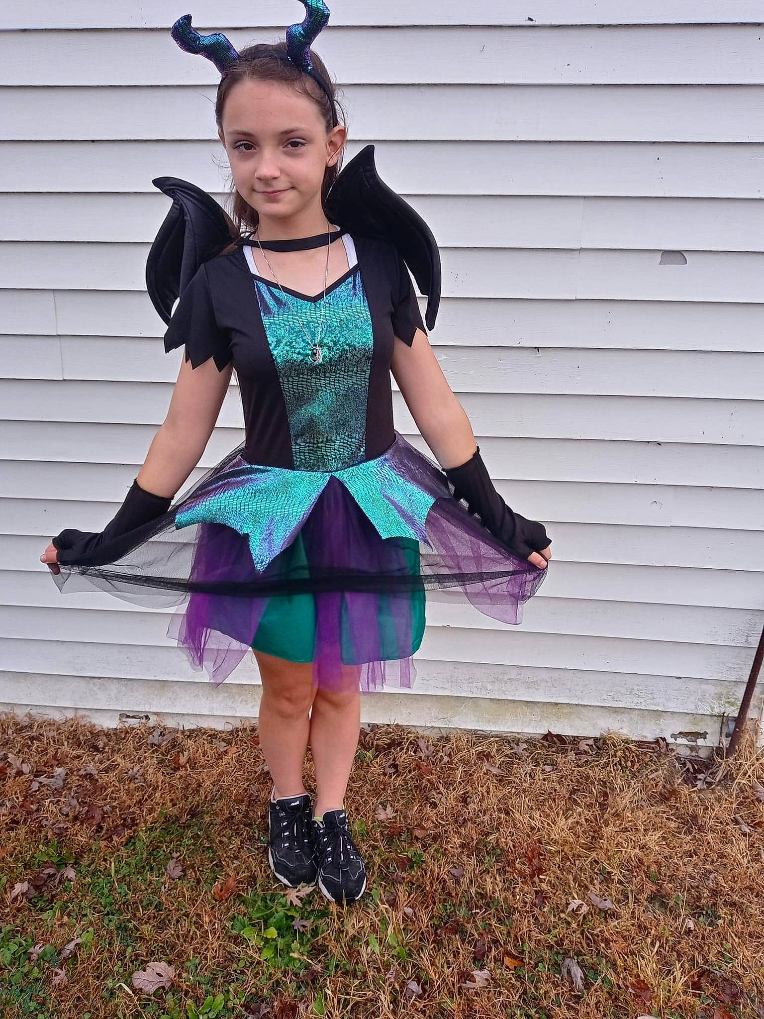 Bella is registered to the contest to win money with this photo: cool, costume, electric_blue, eyewear, fashion_accessory, fashion_design, formal_wear, glove, grass, human_leg, jewellery, joy, knee, magenta, necklace, pattern, person, plaid, purple, smile
