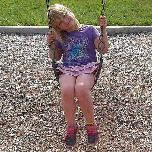 Kaya joined the competition — help win amazing prizes! blond, fun, grass, joy, leg, outdoor_play_equipment, person, play, playground, recreation, shorts, style, swing, thigh